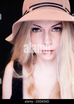 Beautiful woman with long blond har wearing a hat Stock Photo