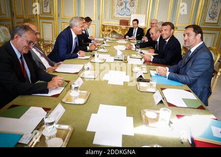 French President Emmanuel Macron, French Interior Minister Christophe Castaner and French Foreign Affairs Minister Jean-Yves Le Drian attend a meeting with Special Envoy of the UNHCR for the Central Mediterranean situation Vincent Cochetel, United Nations High Commissioner for Refugees Filippo Grandi and EU Commissioner for Migration, Home Affairs and Citizenship, Dimitris Avramopoulos at the Elysee presidential Palace in Paris, France on July 22, 2019. Photo by Hamilton/Pool/ABACAPRESS.COM Stock Photo