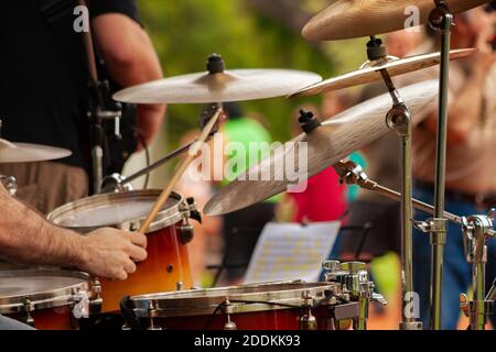 Close Up Of Drummer Playing Snare Drum On Kit In square during musical performace. Stock Photo
