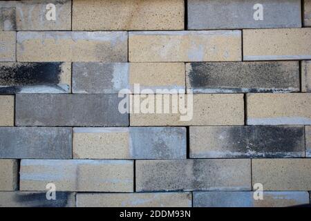 brick wall  with yellow brown black color stone Stock Photo