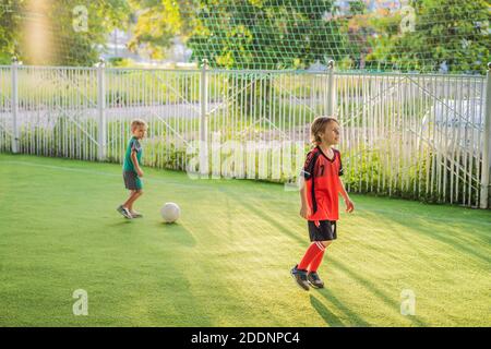 young boys playing football soccer game. Running players in uniforms Stock Photo