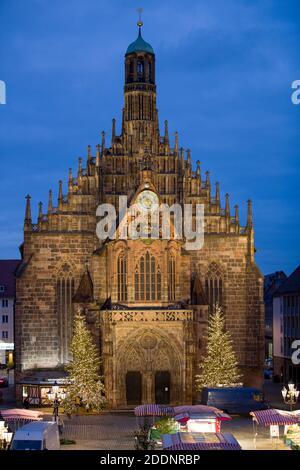 Nuremberg, Germany. 23rd Nov, 2020. View of the blue hour of the Frauenkirche from whose gallery the Nuremberg Christ Child officially opens the Nuremberg Christmas Market on the main market square below. The world-famous Nuremberg Christkindlesmarkt, which was originally scheduled to open on 27.11.2020, is cancelled this year due to the Corona Pandemic. Credit: Daniel Karmann/dpa/Alamy Live News Stock Photo