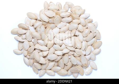 Raw dried pumpkin seeds isolated on white. Heap of pumpkin seeds Stock Photo