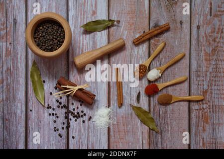 Flat lay of various colorful herbs and spices on wooden background Stock Photo