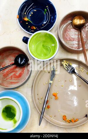 plates and cups after eating, waste food after raw healthy breakfast on the table. vertical photo Stock Photo