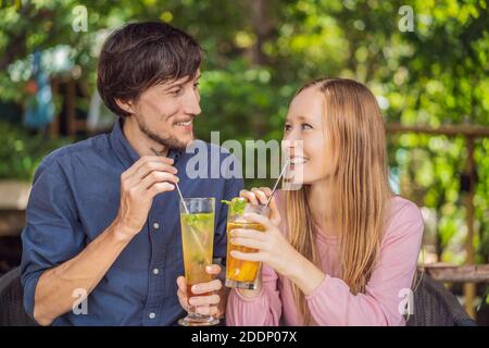 Eco friendly couple using reusable stainless steel straw to drink fruit tea Stock Photo