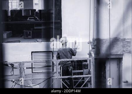 Skilled labourer working on the wall. Stock Photo