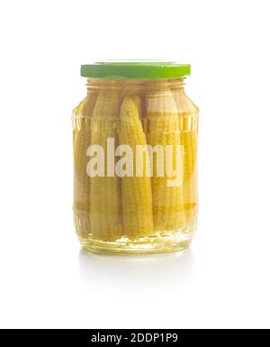 Pickled young baby corn cobs in jar isolated on white background. Stock Photo