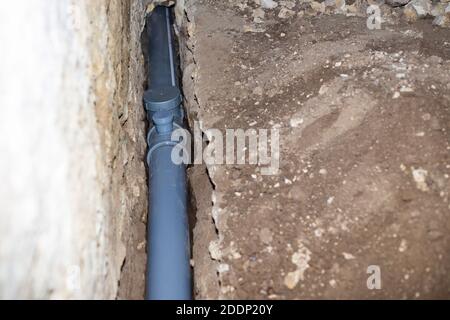 lining sewage with plastic pipes, drainage of waste water from the house. Stock Photo