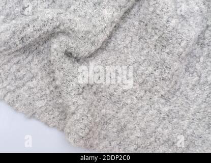 cozy grey knitted textured scarf . top view of a baktus winter scarf. winter outfit. trendy acsessories for women. selective focus Stock Photo