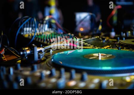 Professional dj turntable.Vinyl record player on stage in night club.Retro analog disc audio equipment for playing musical tracks in high quality.Hip Stock Photo