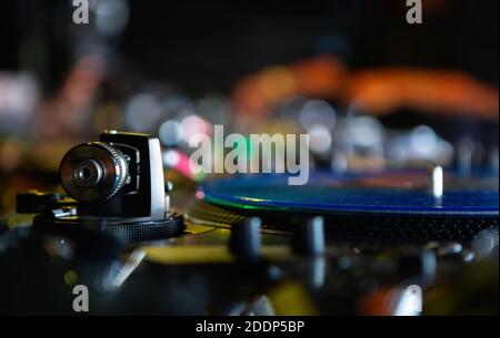 Professional dj audio equipment.Analog turntables tonearm with needle and vinyl record disc with hip hop music.Djs setup for playing musical tracks on Stock Photo