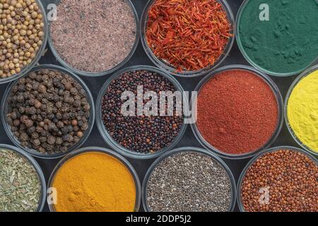 Different spices and herbs on background, close up, top view. Assortment colorful spices, seeds and herbs for cooking food Stock Photo