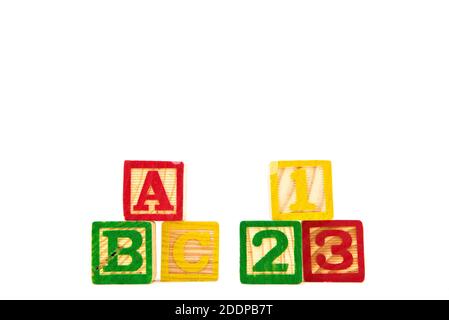 Colored letter cubes made from wood spelling ABC and 123 to illustrate the concept of learning. Isolated on white. High quality photo Stock Photo