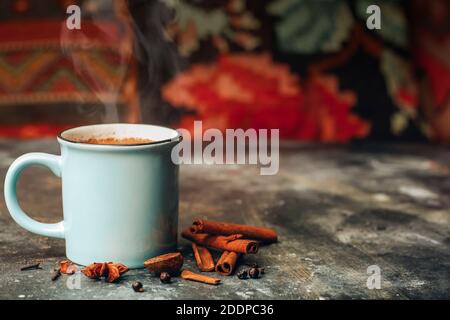 Masala tea (masala chai). Hot Indian drink based on milk and tea with the addition of spices and herbs. Stock Photo