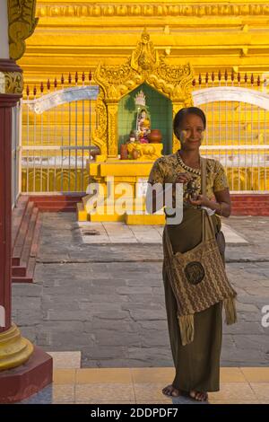 Woman with thanaka on cheeks at Kuthodaw Pagoda, Myanmar (Burma), Asia in February Stock Photo