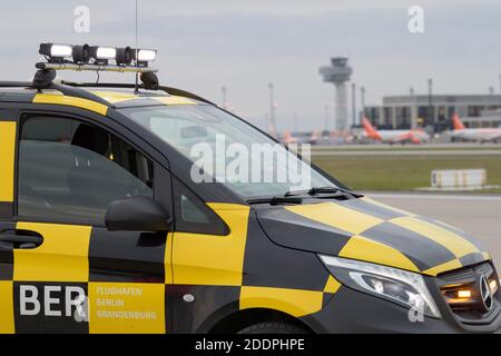 03 November 2020, Brandenburg, Schönefeld: A 'Follow me' vehicle stands on the southern runway against the backdrop of the tower and Terminal 1 of Berlin Brandenburg Airport (BER). Photo: Soeren Stache/dpa-Zentralbild/ZB Stock Photo