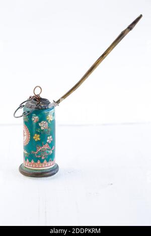 Antique opium pipe on a white wooden table with copy space Stock Photo