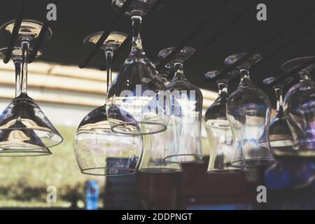 Wine glasses hang over the bar Stock Photo