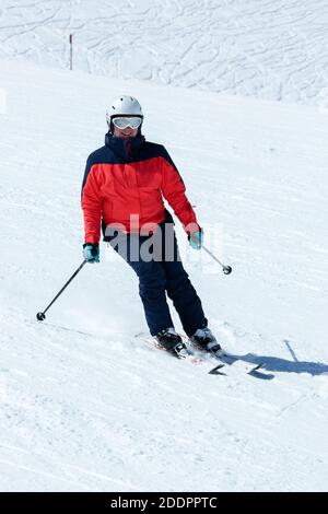 Female skier in downhill slope. Winter sport recreational activity. Alps. Austria Stock Photo