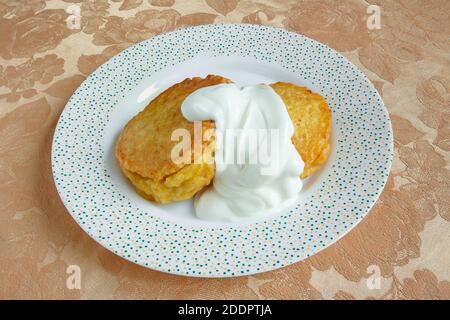 The Belarusian national dish is potato pancakes with sour cream. Stock Photo