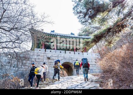 Korean hikers climbing the rock at the Bukhansan Mountain National park in Soeul, South Korea. Stock Photo