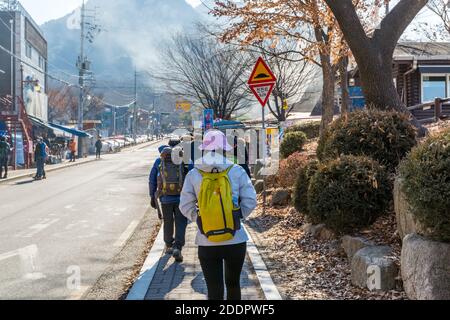 Korean hikers climbing the rock at the Bukhansan Mountain National park in Soeul, South Korea. Stock Photo