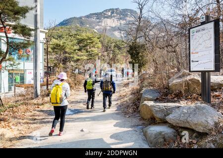 Korean hikers climbing the rock at the Bukhansan Mountain National park in Soeul, South Korea. Stock Photo