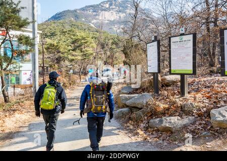 Korean hikers climbing the rock at the Bukhansan Mountain National park in Soeul, South Korea. Stock Photo