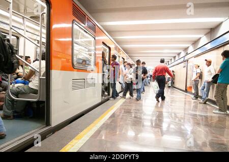 Mexico DF State/Mexico 12/27/2009. Subway arriving and people walking and standing in platform Subway station Mexico City. Stock Photo