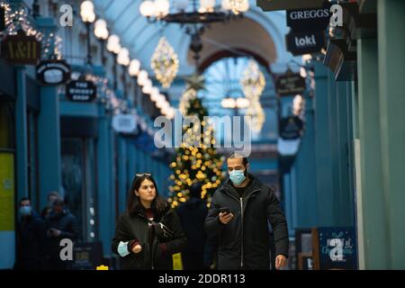 People walk through Great Western Arcade in Birmingham, which will enter Tier 3 after the four week national lockdown to curb the spread of coronavirus. Stock Photo