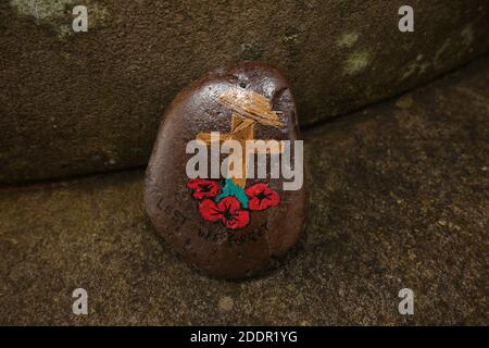 Painted stones depicting scenes from the war to commerate remembrance around stone pillar in Auchinleck Parish Church, Ayrshire, Scotland Stock Photo