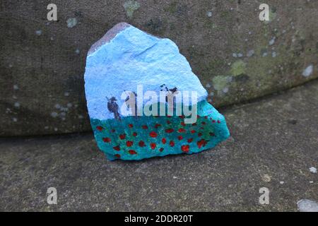 Painted stones depicting scenes from the war to commerate remembrance around stone pillar in Auchinleck Parish Church, Ayrshire, Scotland Stock Photo