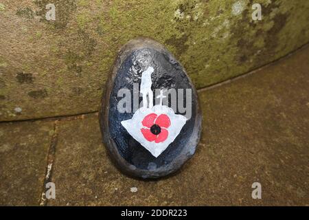 Painted stones depicting scenes from the war to commerate remembrance around stone pillar in Auchinleck Parish Church, Ayrshire, Scotland Stock Photo