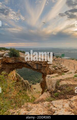 Sunset view of the Keshet Cave, a limestone archway spanning the remains of a shallow cave, in Adamit Park, Western Galilee, Northern Israel Stock Photo