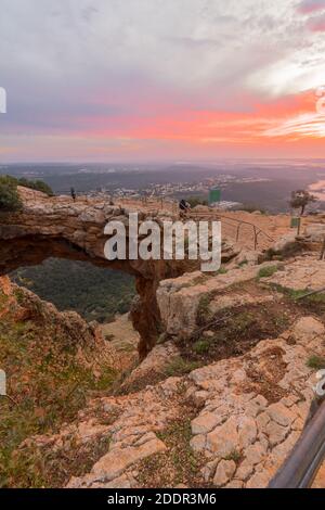 Sunset view of the Keshet Cave, a limestone archway spanning the remains of a shallow cave, in Adamit Park, Western Galilee, Northern Israel Stock Photo