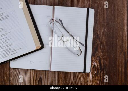 Los Angeles CA US 01 JULY 2020: Morning study with open Holy Bible with notepad on wooden background Stock Photo