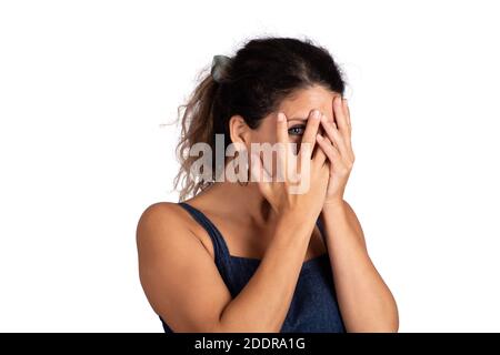 Young woman looking shy hiding behind her hand. Stock Photo