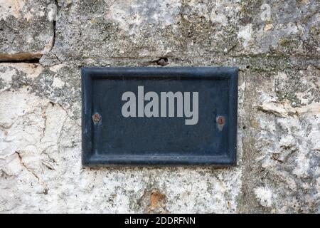 Street number blank metal vintage plate mounted on stone wall. Traditional house address template, copy space Stock Photo