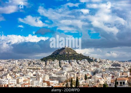 Mount Lycabettus and Athens cityscape view from Acropolis hill in Greece, blue cloudy sky, sunny day Stock Photo