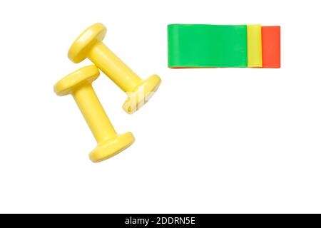 Yellow dumbbells and set of fitness rubber bands isolated on white background. Stock Photo