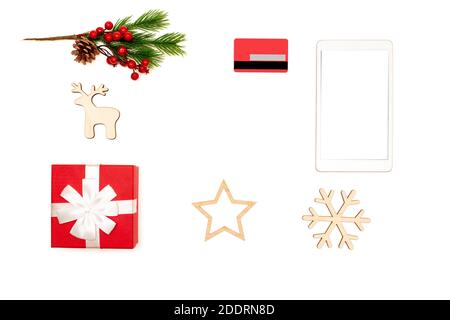 Frame made of digital tablet, credit card, gift box and christmas toys on white background top view Stock Photo