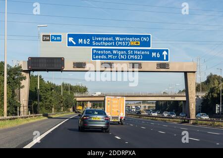 UK motorway, road sign showing directions to A49 Warrington, Newton and M62 Liverpool, St Helens, Southport (M57) Stock Photo