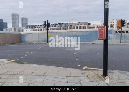 A n empty urban landscape of a pedestrian crossing that leads nowhere in Stratford during the second wave of the Coronavirus pandemic, on 26th November 2020, in London, England. Stratford was the home of the London 2012 Olympics where industrial estates centred around Carpenters Road were demolished to make way for sports venues  and now, after 8 years, for extensive housing. In the week of 8th-14th November, the east London borough of Newham (including Stratford) reported 703 positive cases (an increase of 13 from the previous 7 days) with a total of 6,259 cases. Stock Photo