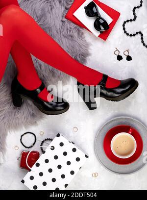 Womens legs in fashionable shoes on gray furry background Stock Photo