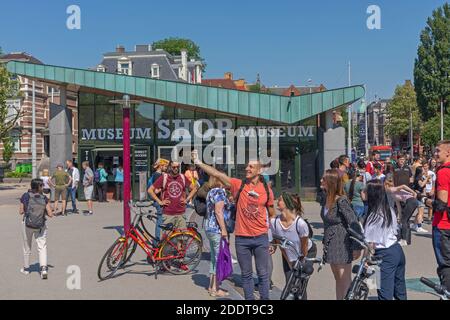 Amsterdam, Netherlands - May 15, 2018: Crowd of Tourists in Front of Museum Shop Building in Amsterdam, Holland. Stock Photo