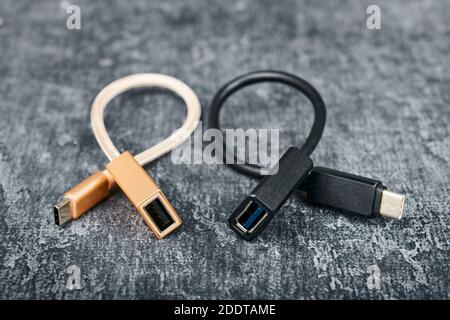Two USB cable type A to type C, compatible for many devices, on gray background, shallow depth of sharpness Stock Photo