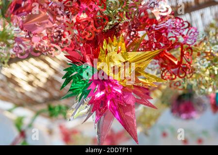 Colorful festive decoration shiny garland at sunset light. Stock Photo