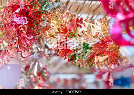 Colorful festive decoration shiny garland at sunset light. Stock Photo