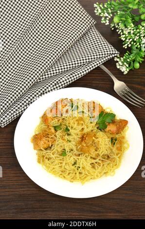 Konjac or Shirataki noodles with pork, grilled meat and herbs. Japanese traditional dish. Healthy food for weight loss, keto diet concept. Rice glass Stock Photo